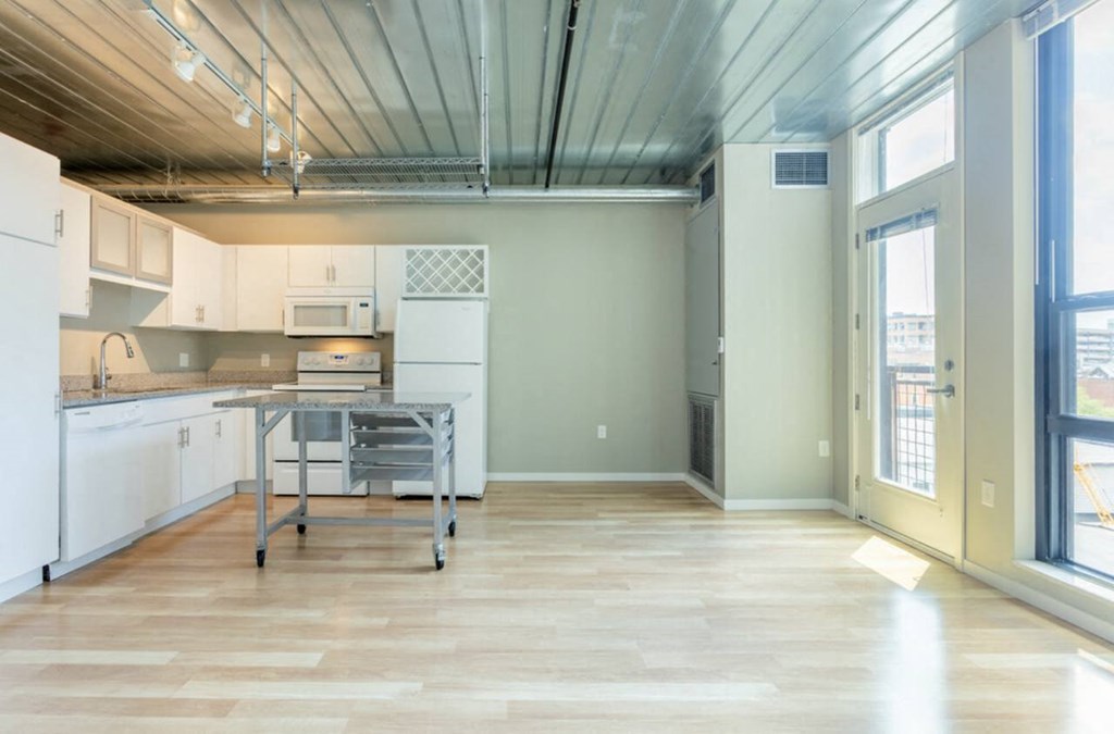a large kitchen with a table in the middle at Ann Arbor City Club, Michigan, 48104